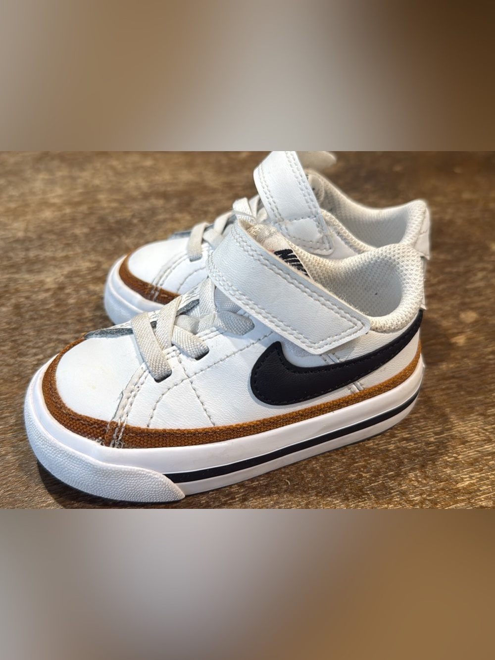 Nike Kids White Sneakers with Black Swoosh and Brown Trim